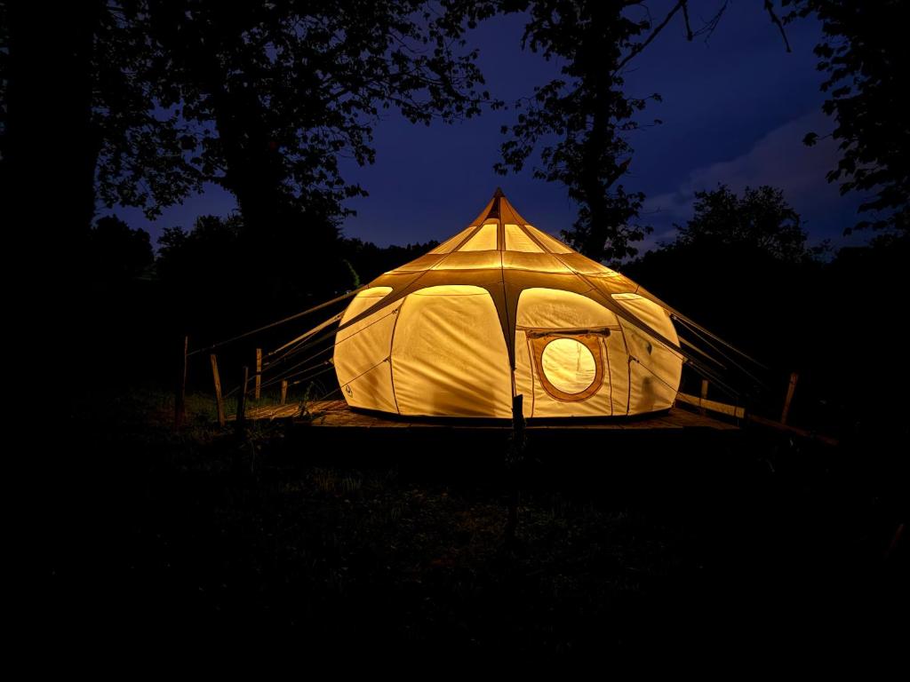 a white tent is lit up at night at Nuit astrale en pleine nature in Solignac