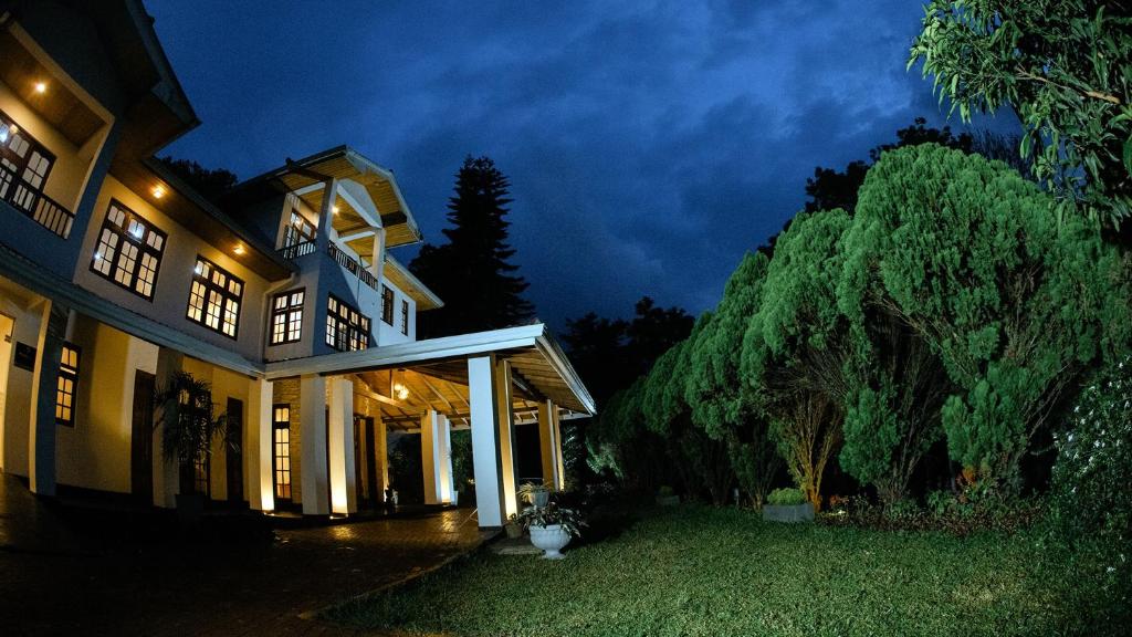 a large house at night with the lights on at Richmond Hill Estate bungalow in Kandy