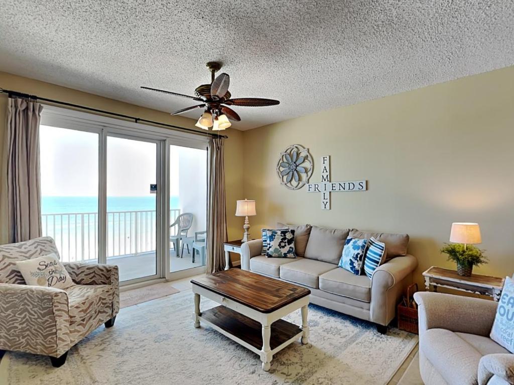 a living room with a couch and a ceiling fan at Windemere #606 in Perdido Key