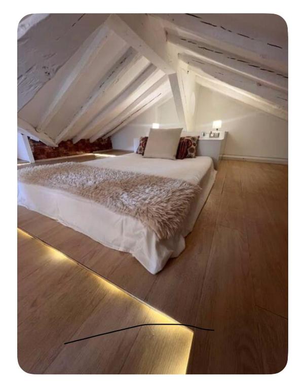 a bedroom with a large bed in an attic at Downtown Dreams in Madrid
