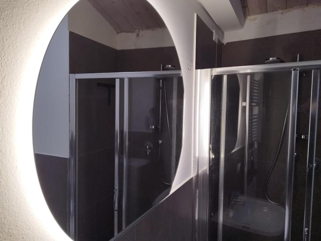 a mirror on a wall in a bathroom at Le Torri Loft, exclusive comfort in the city center in Forlì
