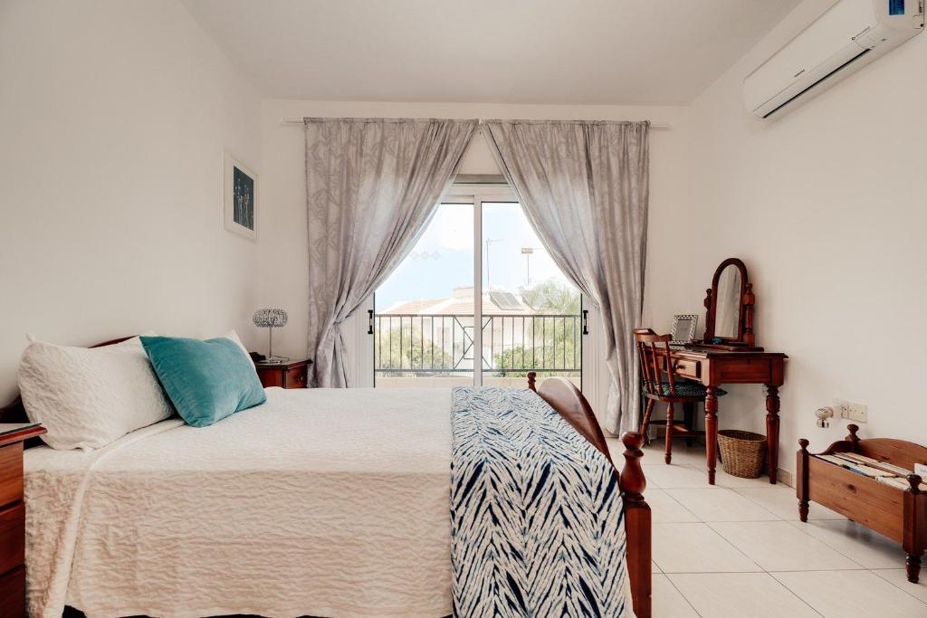 a bedroom with a bed and a window and a piano at Felicity - Geography of Sea - Villa with Private Pool near Kapparis Beach, Protaras in Paralimni