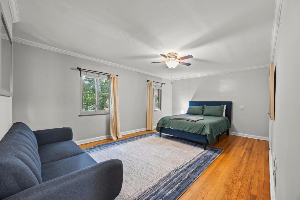 a living room with a couch and a bed at Spacious 3BR Home 5 Mins to Airport and Downtown in Columbus