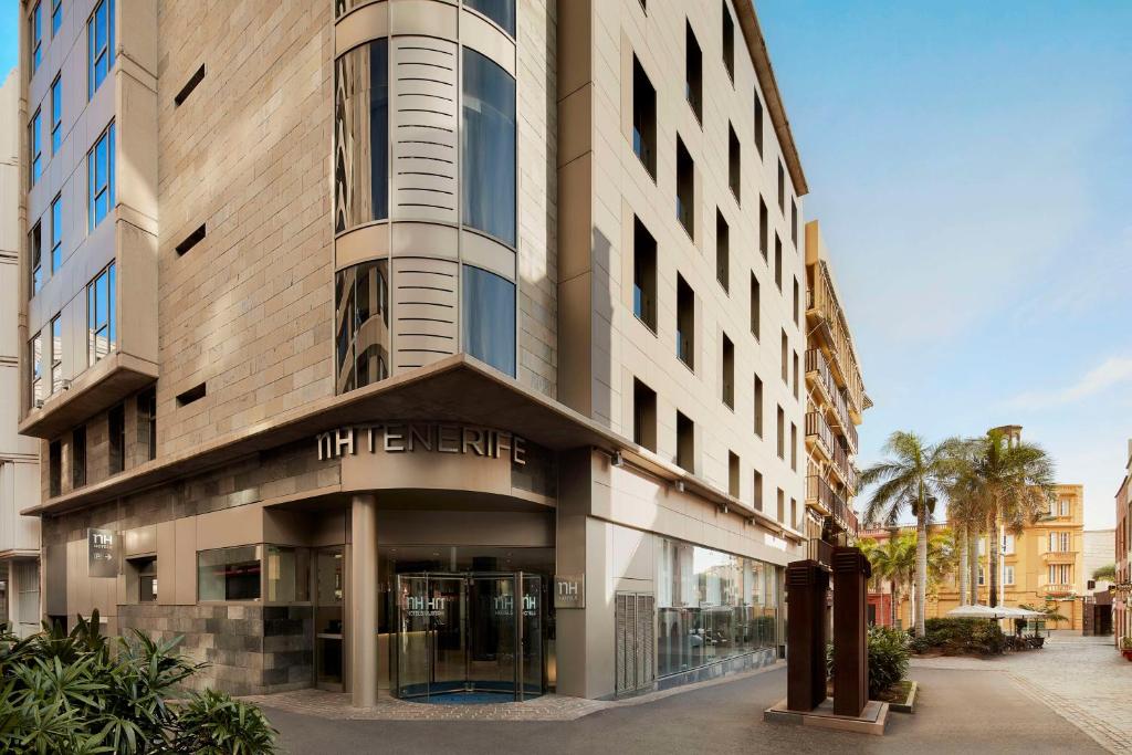 a large building with a sign on the side of it at NH Tenerife in Santa Cruz de Tenerife
