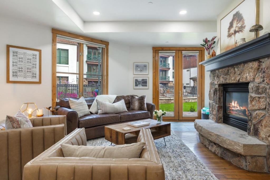 a living room with couches and a fireplace at 118 Villa Montane in Avon