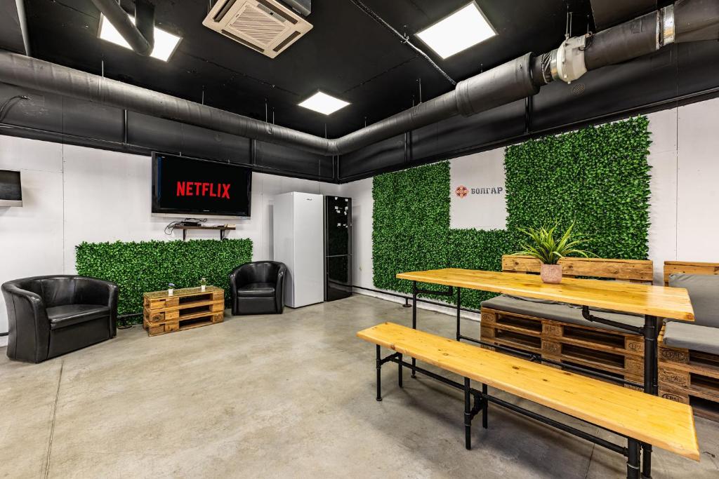 a waiting room with benches and a green wall at Heart of the city Hostel in Varna City