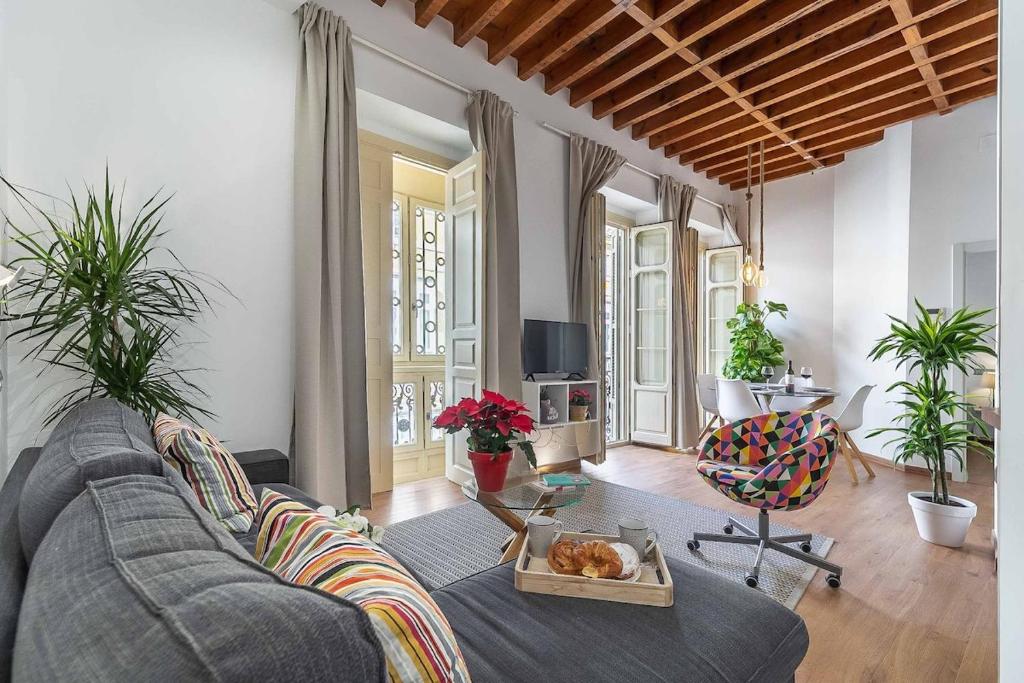 a living room with a couch and a table at Top-Class Larios Executive Suite - Malaga Center in Málaga