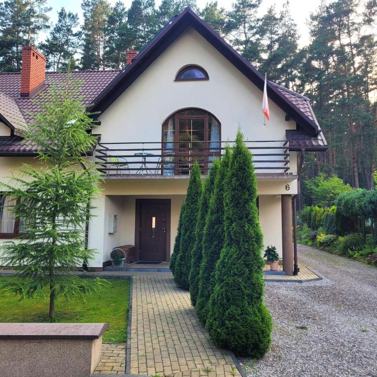 a white house with a pathway leading to it at Willa Roztocze in Zwierzyniec