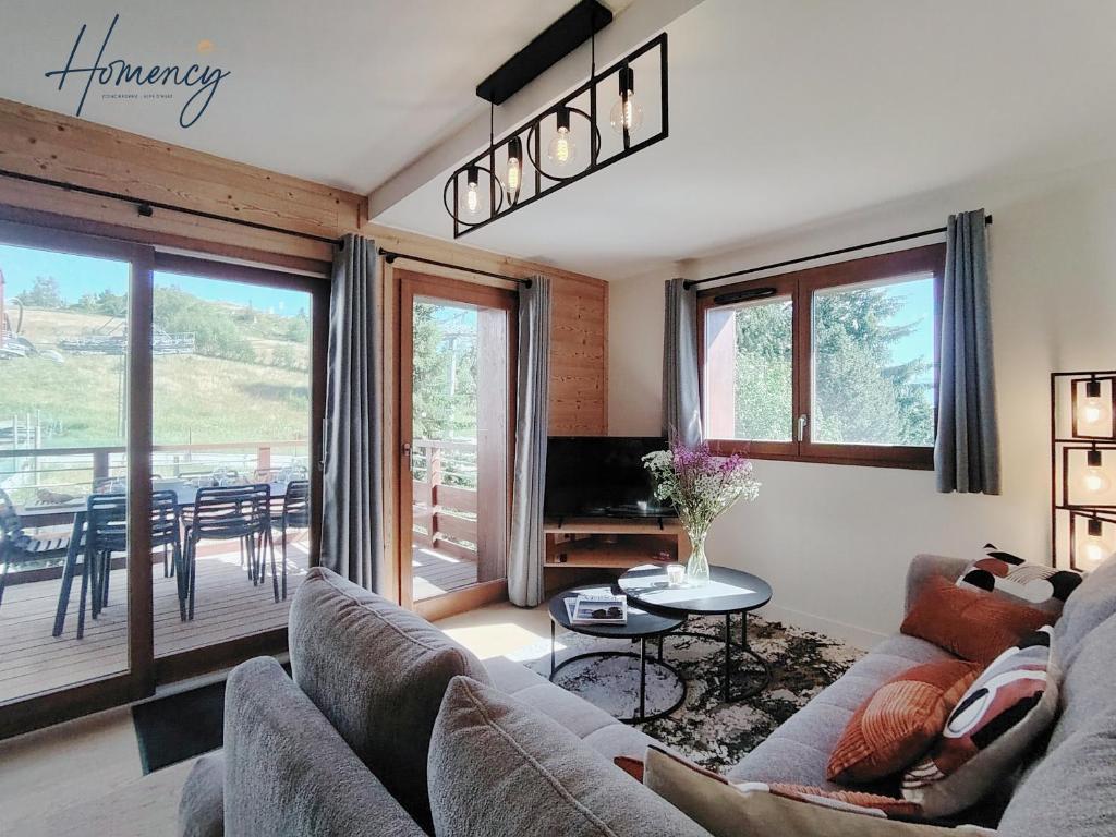 a living room with a couch and a table at Homency - Résidence Parenthese A28 in L'Alpe-d'Huez