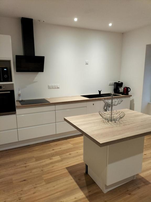 a kitchen with white cabinets and a counter top at Indivision Bernard Pillaud in Chantonnay