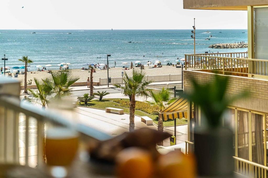 a view of the beach from the balcony of a resort at Exclusive Deluxe Apartment - Fuengirola Beachfront in Fuengirola