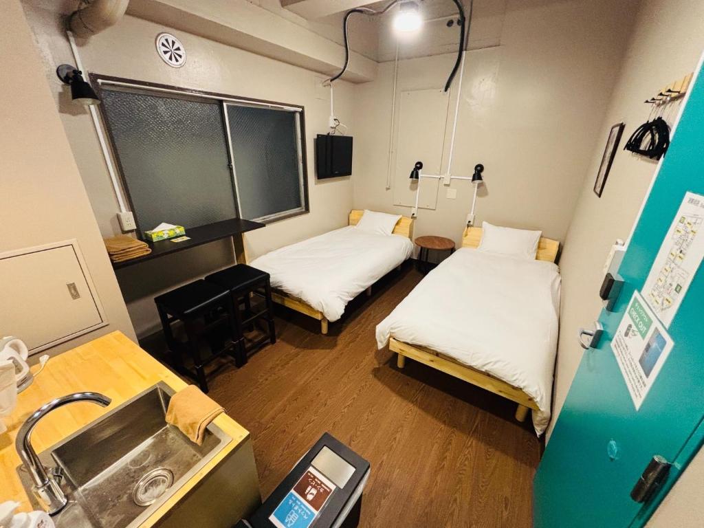 a hospital room with two beds and a sink at Wasabi Mita Hotel - Vacation STAY 84674v in Tokyo