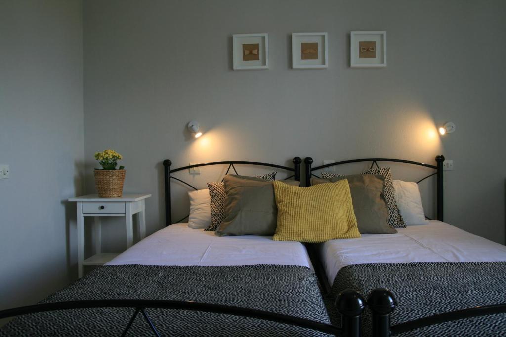 a bedroom with a bed with pillows on it at Vasilina in Faliraki