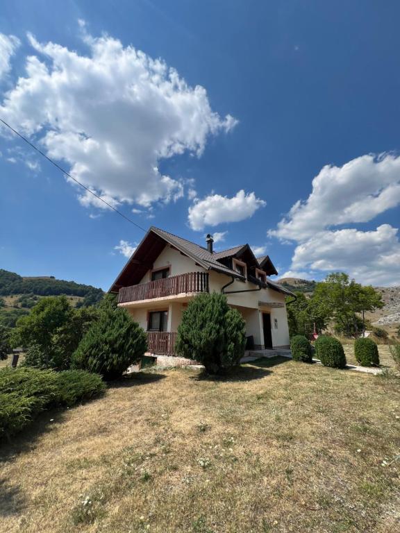a house on a hill with a yard at Vikendica u srcu Bjelasnice in Trnovo