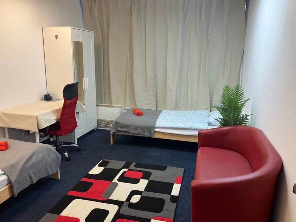 a room with a bed and a chair and a couch at Viola Hostel in Budapest