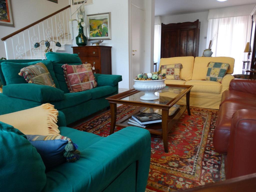 ein Wohnzimmer mit blauen Sofas und einem Couchtisch in der Unterkunft Silenzi Holiday Home in Fertilia