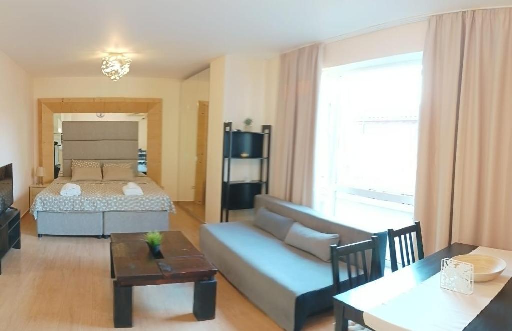 a living room with a couch and a bed at Atlantic in Pomorie
