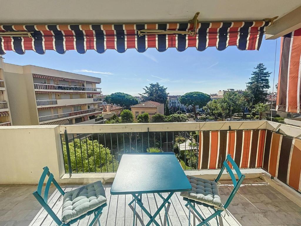 une table et des chaises sur un balcon avec vue dans l'établissement Blue sky-Plage 2min-Plein Sud, au Golfe-Juan