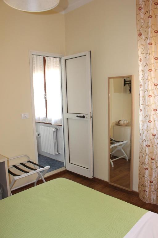 a bedroom with a bed and a sliding glass door at B&B I' Chivi in Incisa in Valdarno
