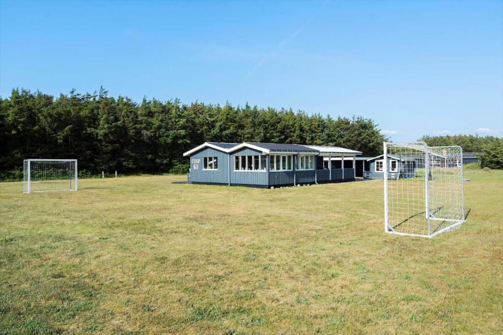 two soccer nets in a field with a building at 268-Ringkobing-Lyngvejen-63 in Klegod