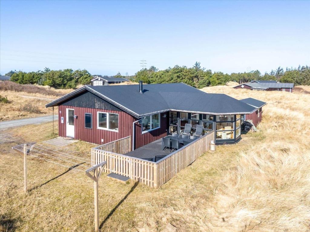 an overhead view of a red house in a field at 280-Ringkobing-Klitsvinget-11 in Klegod