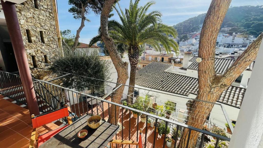 a balcony of a house with palm trees at T5 · Cozy Retreat 50m to Beach Garden Escape in Tamariu