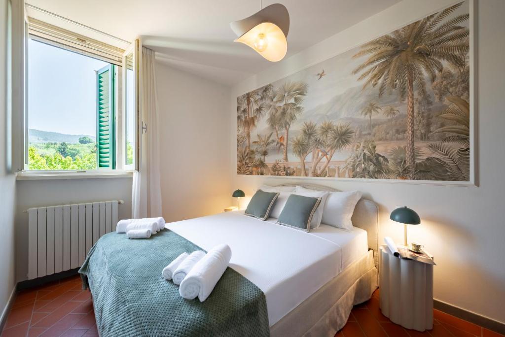 a bedroom with a bed and a large window at NEW Apartment Fiordaliso in Vinci