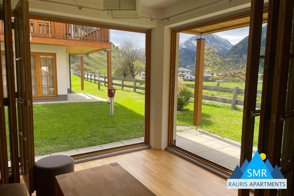 a sliding glass door with a view of a yard at Isabella 2 by SMR Rauris Apartments - inc Spa and near Gondola in Rauris