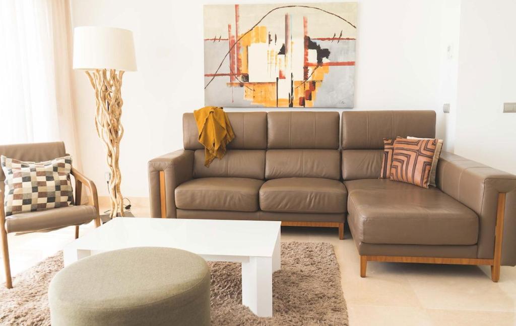 a living room with a couch and a coffee table at Exclusivo Atico en La Cala Golf in La Cala de Mijas