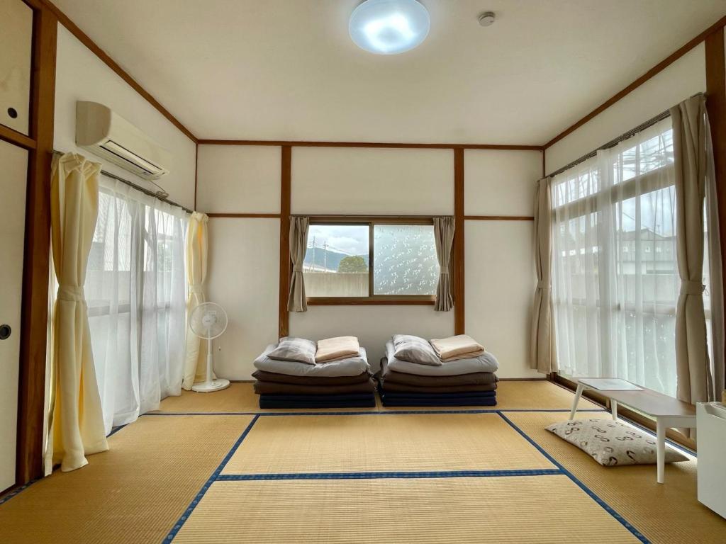 a room with two beds in a room with windows at Kaen - Vacation STAY 19037 in Aso