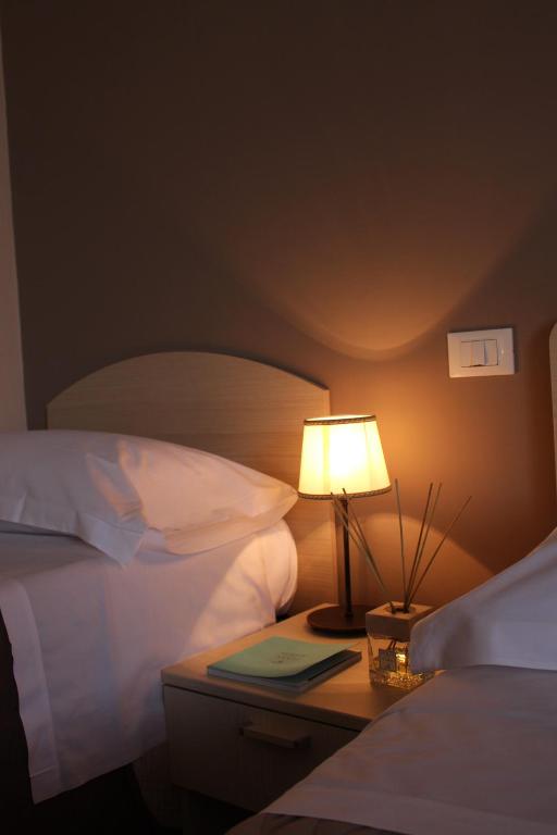 a lamp on a night stand next to a bed at B&B I' Chivi in Incisa in Valdarno