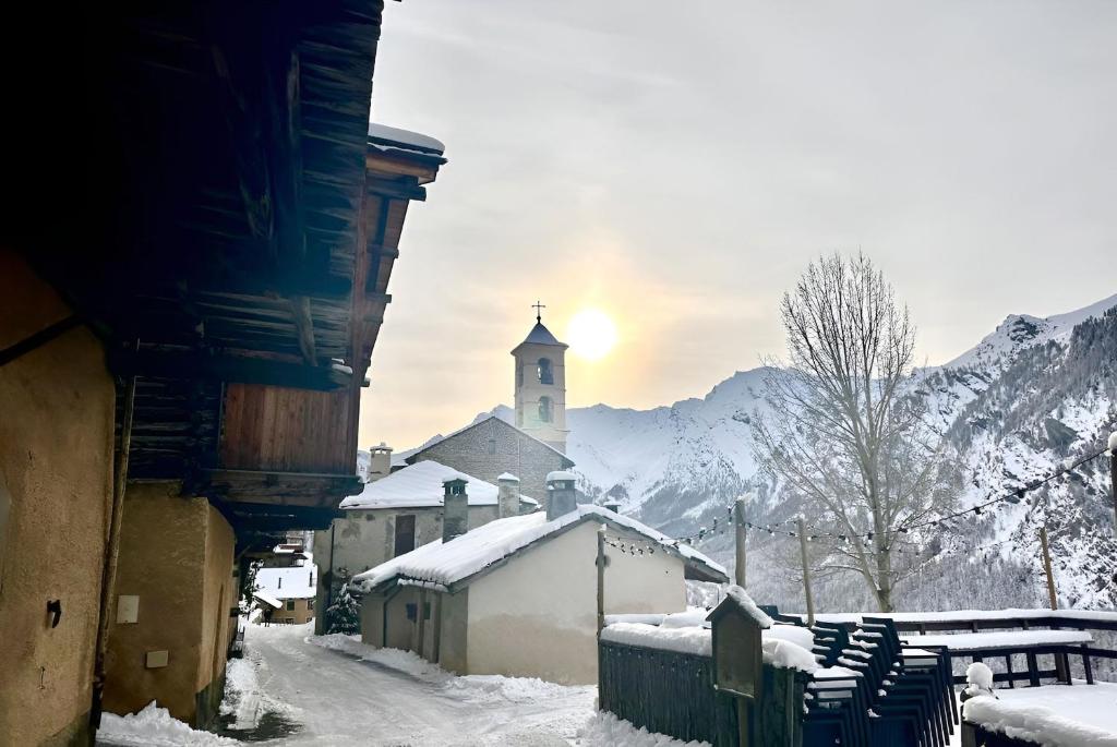a small village with a church in the snow at Casa-La Fuste centre Saint-Véran ski au pied in Saint-Véran