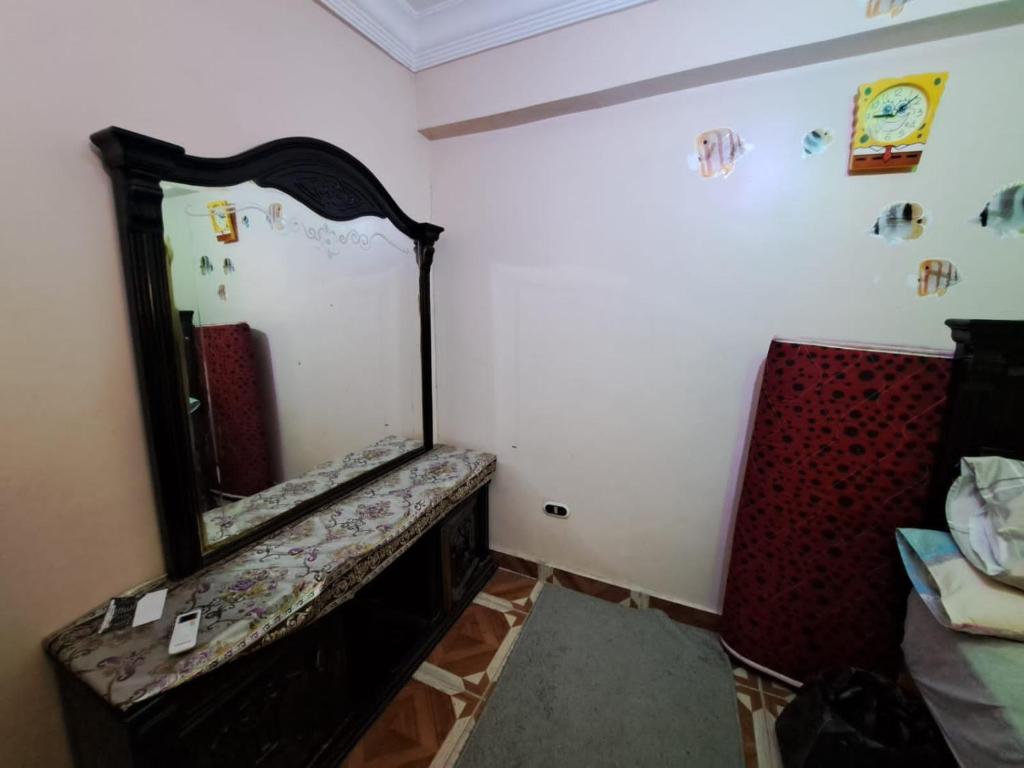 a room with a mirror and a couch in it at KENZY Apartment in Alexandria