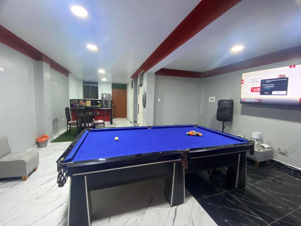 a pool table in a living room with at La casa del Panda in San Antonio