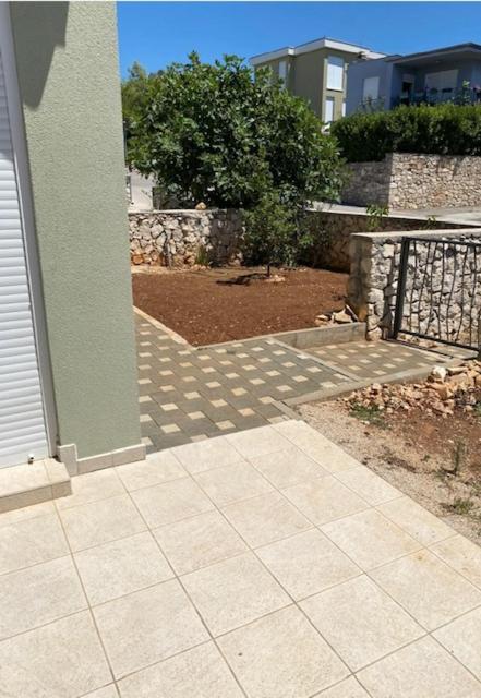 a walkway outside of a house with a fence at Adria in Brodarica