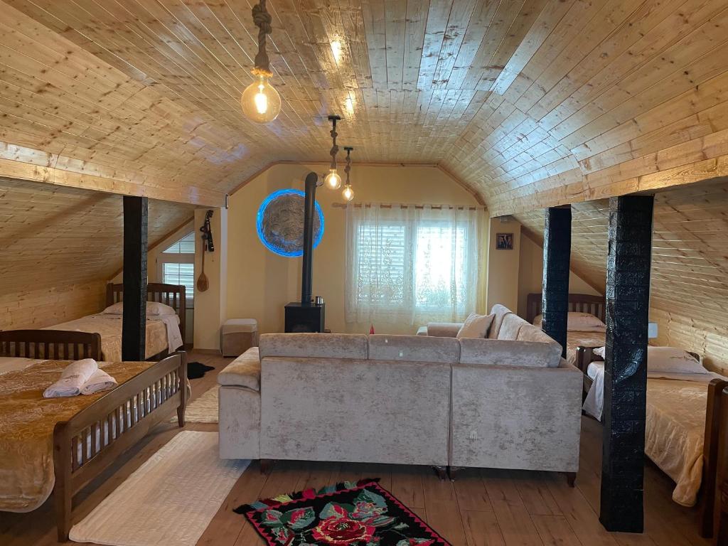 a large living room with a couch and two beds at Riza Guest House in Pukë