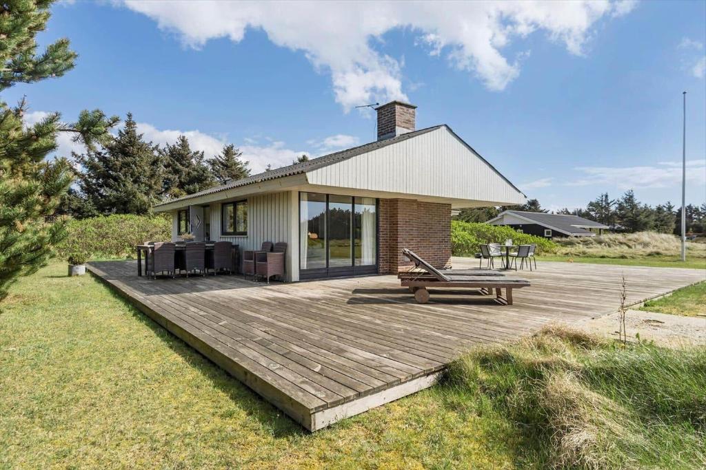 a house with a wooden deck in front of it at 1082-Ringkobing-Milevej-11 in Klegod