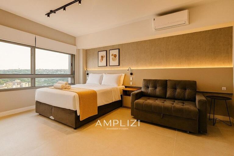 a hotel room with a bed and a couch at Linked Ampllizi in Porto Alegre