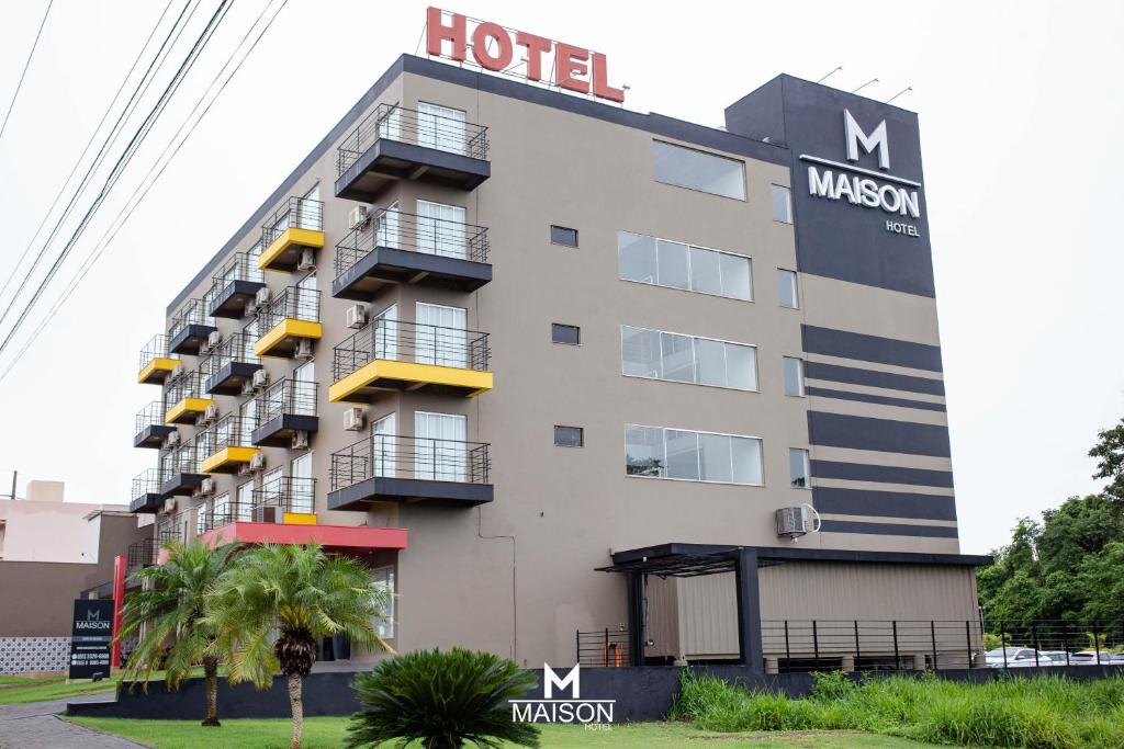 a hotel with a sign on the side of it at Maison Hotel - Tangará da Serra in Tangara da Serra
