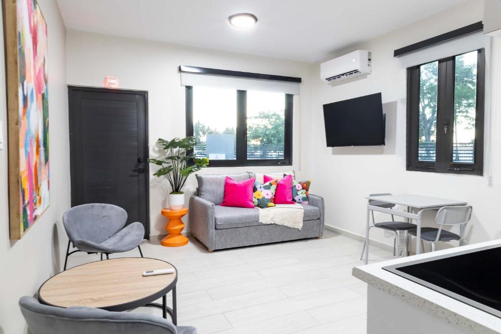 a living room with a couch and a table at Fully Renovated ADA-Accessible Beachside with Oceanview 1 Bedroom Unit 6 in Dorado