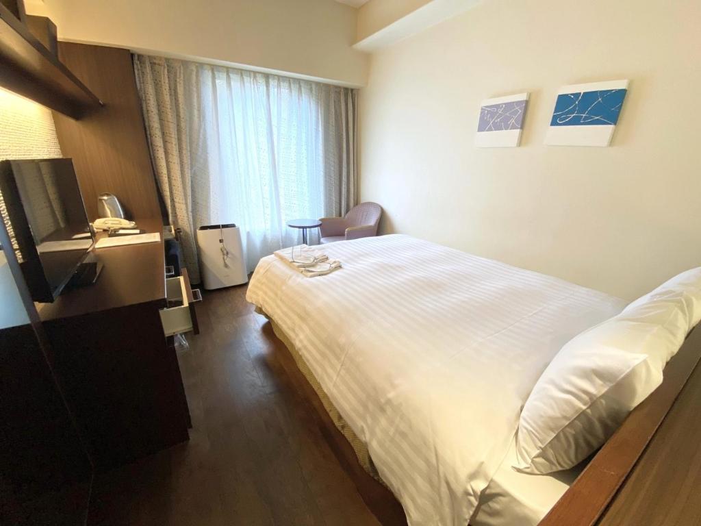 a hotel room with a bed and a television at Smile Hotel Tokyo Nishikasai - Vacation STAY 67980v in Tokyo