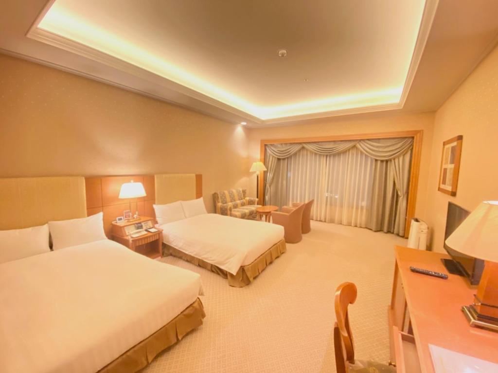a hotel room with two beds and a couch at Smile Hotel Tokyo Nishikasai - Vacation STAY 67977v in Tokyo