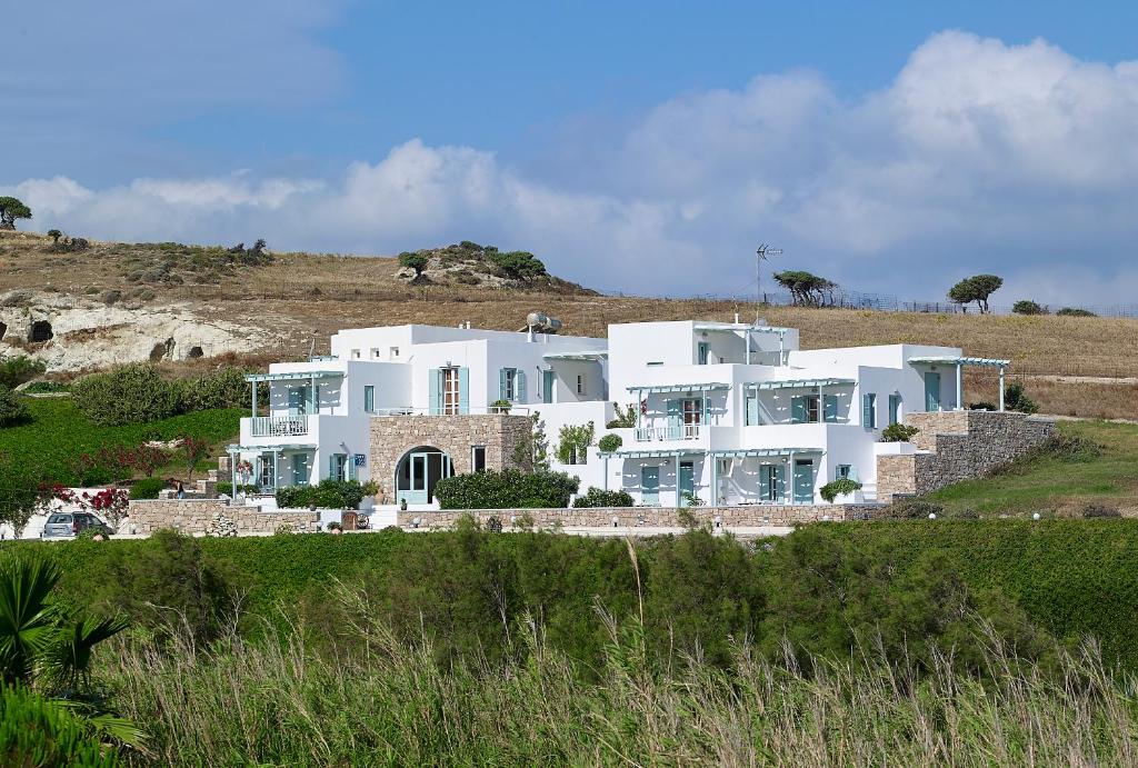 a large white house on top of a hill at Asterias Boutique Hotel in Pachaina