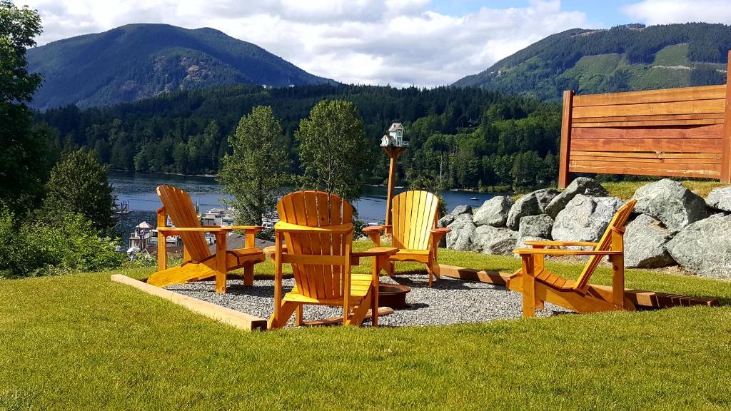 a group of chairs sitting around a table in the grass at Cowichan Calling in Lake Cowichan