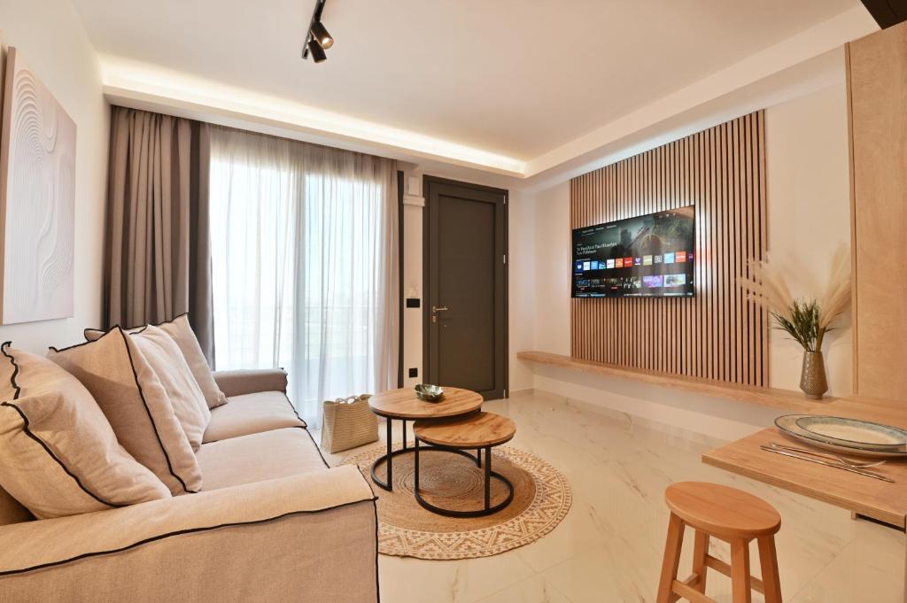 a living room with a couch and a table at Terra luxury apartments in Preveza