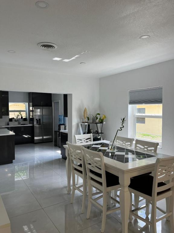 Una cocina y un comedor con mesa y sillas. en North Miami Vacation Home, en North Miami Beach