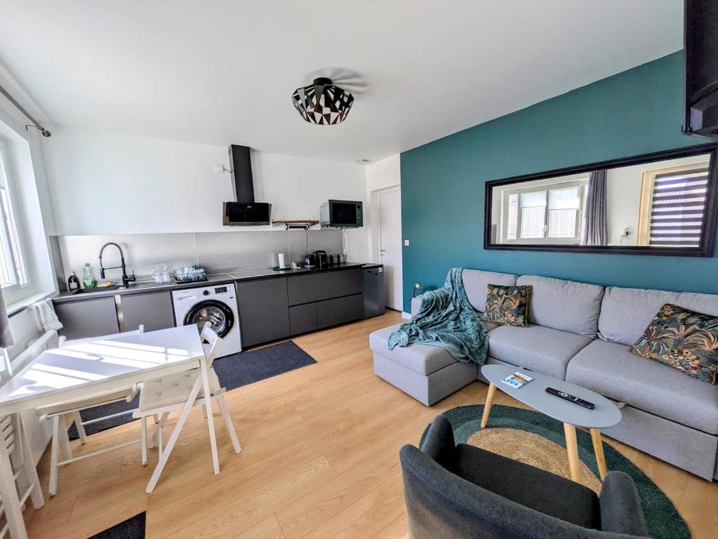 a living room with a couch and a table at Gite Bernard Lafon in Castillon-la-Bataille