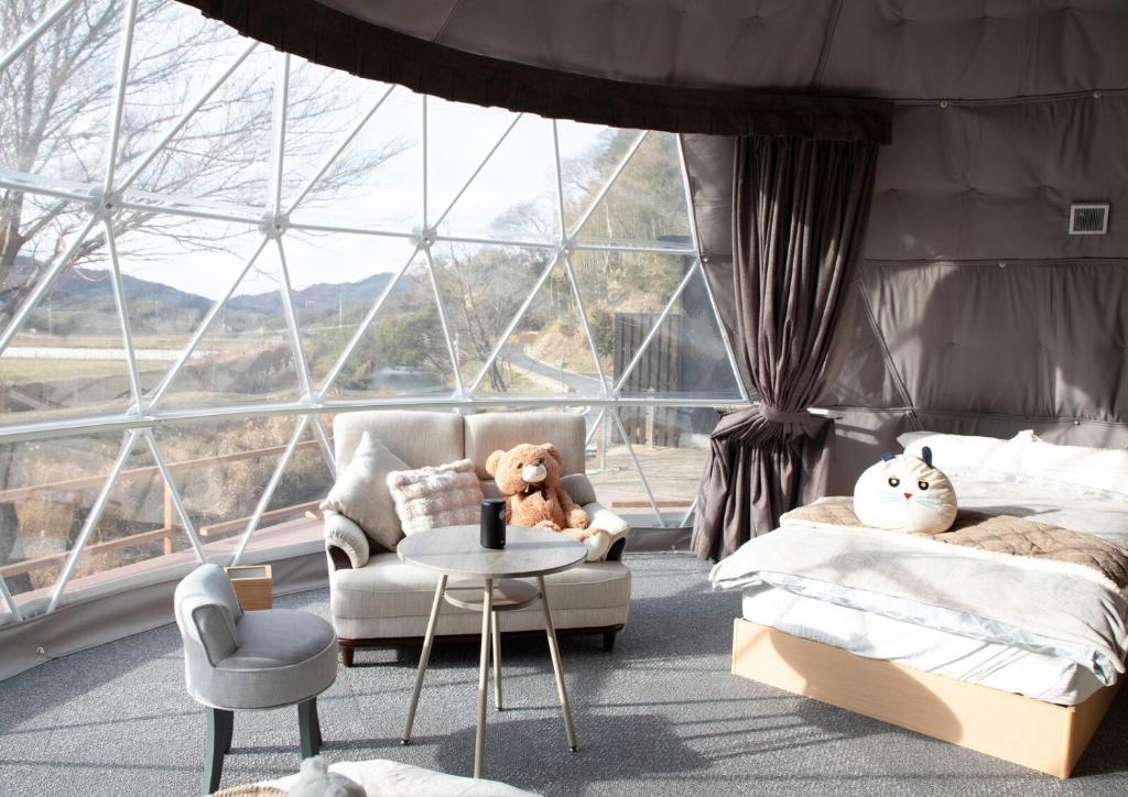 a bedroom with a bed and a chair and a table at Awaji Island Ayayagumi Waterfall Terrace - Vacation STAY 81025v in Ōno