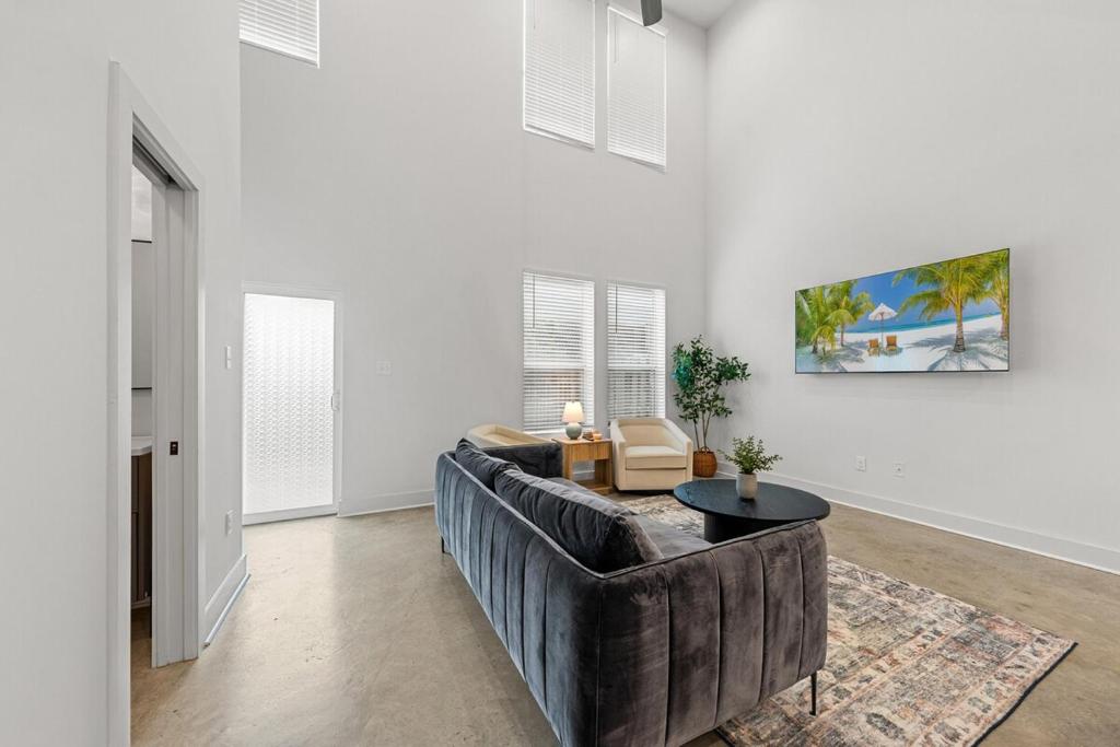 a living room with a couch and a table at Voodoo House KING Bed Garage Fast WiFi 65 Tv in Lafayette