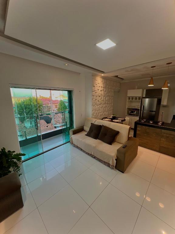 a large bedroom with a bed and a kitchen at Flat Jijoca in Jijoca de Jericoacoara